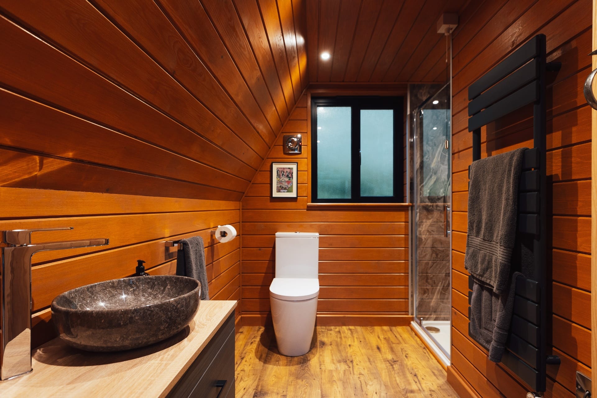 Timber-clad bathroom with stone basin and walk-in shower at The Perch