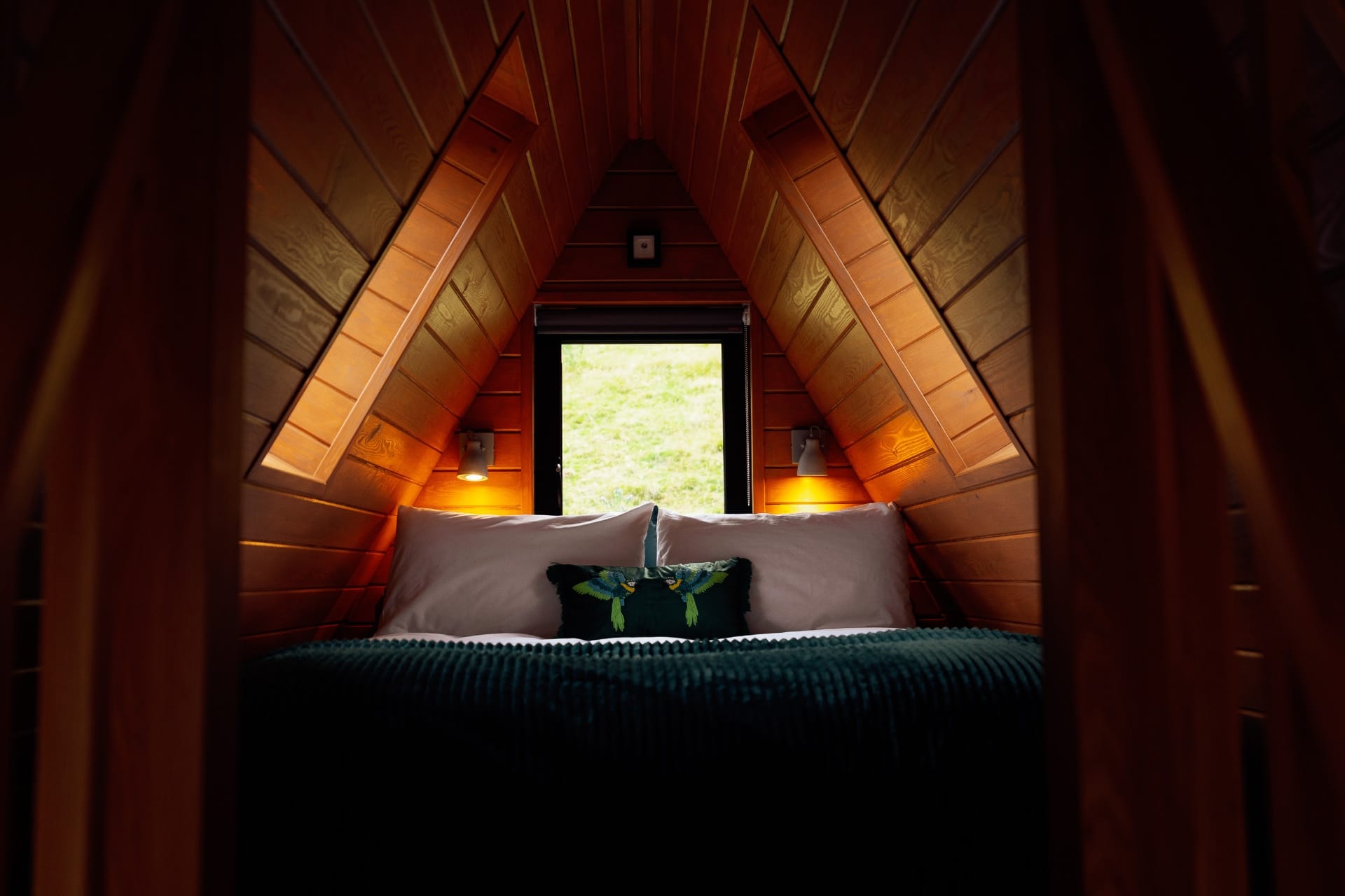 King-size mezzanine bed under the A-frame rafters at The Perch