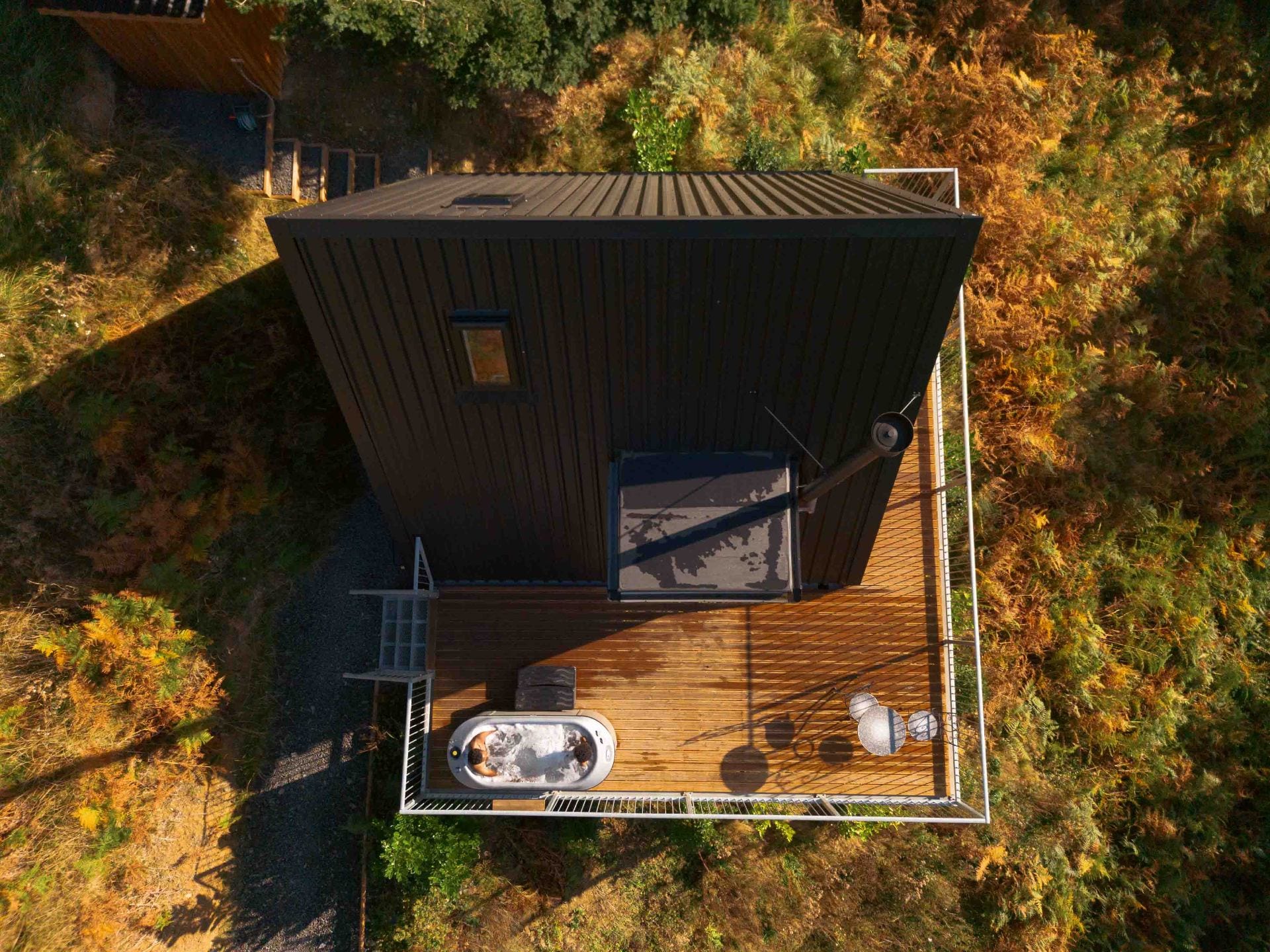 Aerial view of The Perch deck with private hot tub overlooking the Welsh hills