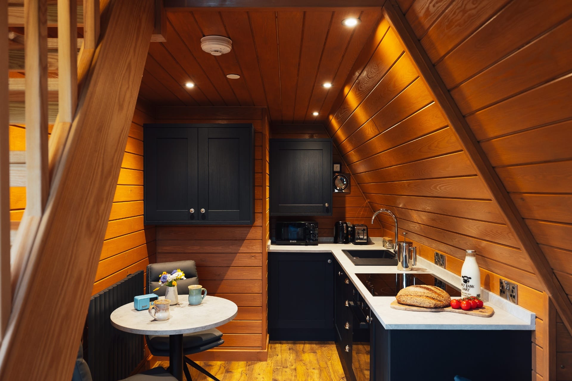 Navy and timber kitchen with bistro table at The Perch