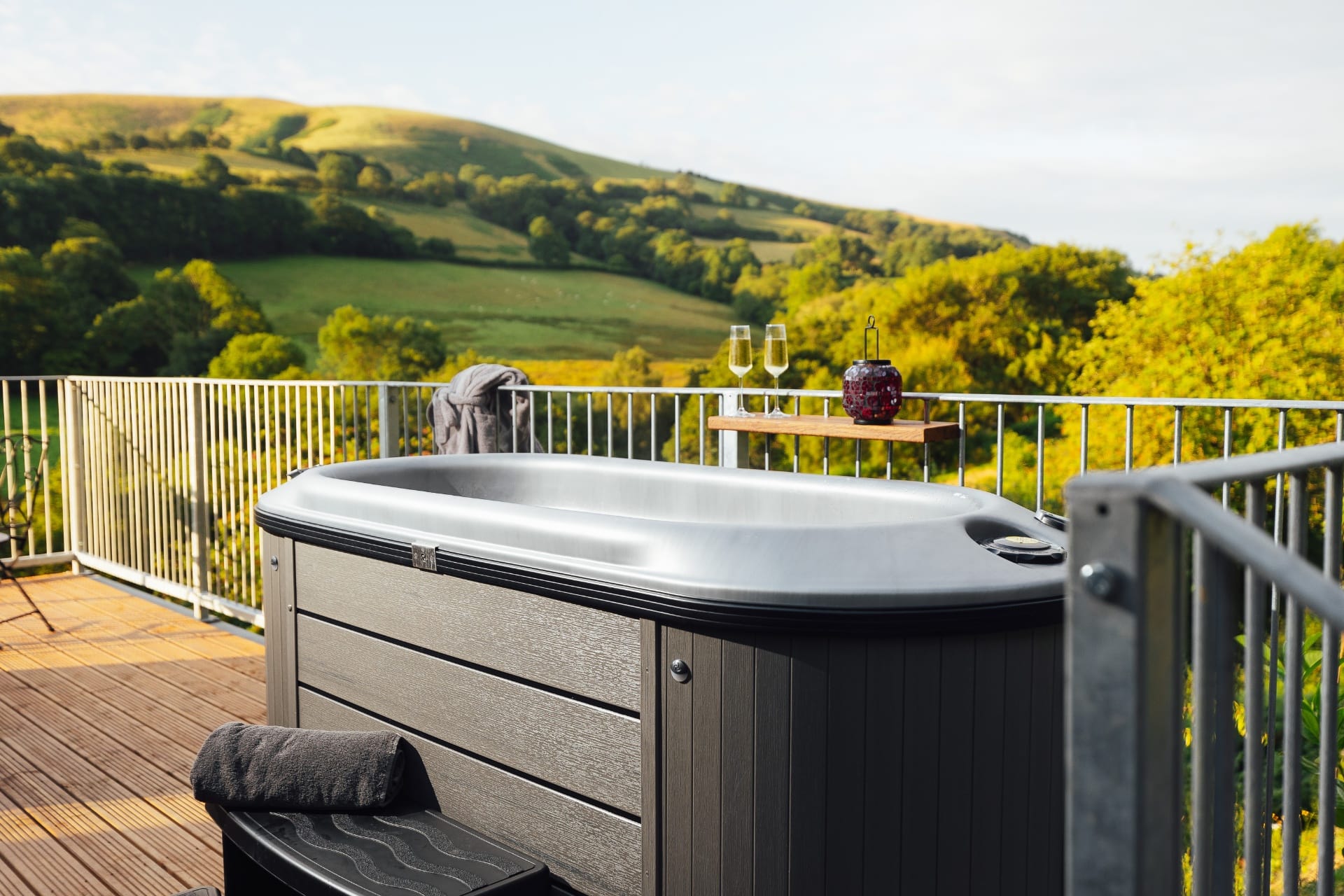 Private hot tub on the deck overlooking the Welsh hills at golden hour