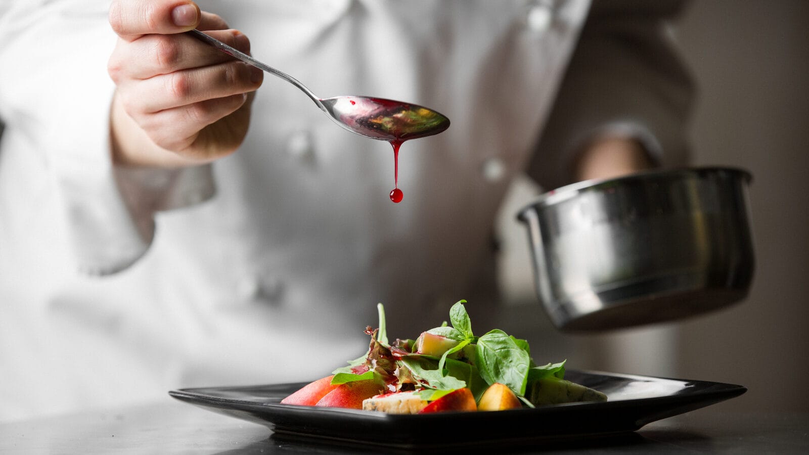 Chef plating a seasonal dish at a local mid Wales restaurant